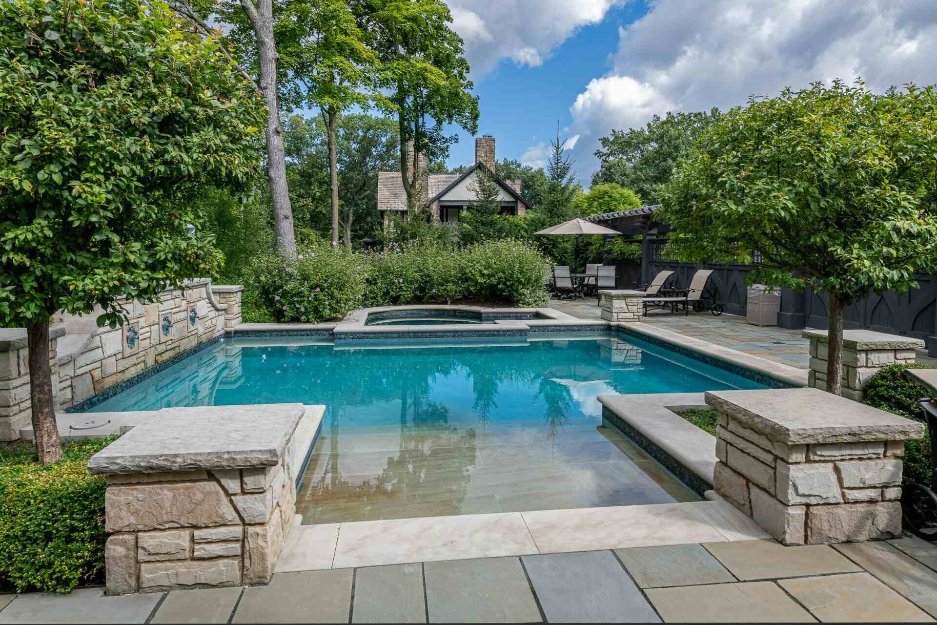 Luxury poolside lounge with resort-style seating at a private estate in South Russell, OH